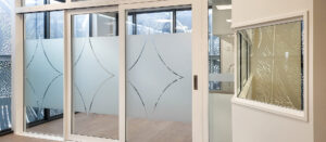 White aluminium sliding doors inside an new interior space.