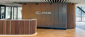 New Showroom with timber wall panels, lights, and white acoustic ceiling.