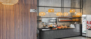 Wooden panelling in a café fitout with counter area in the background.