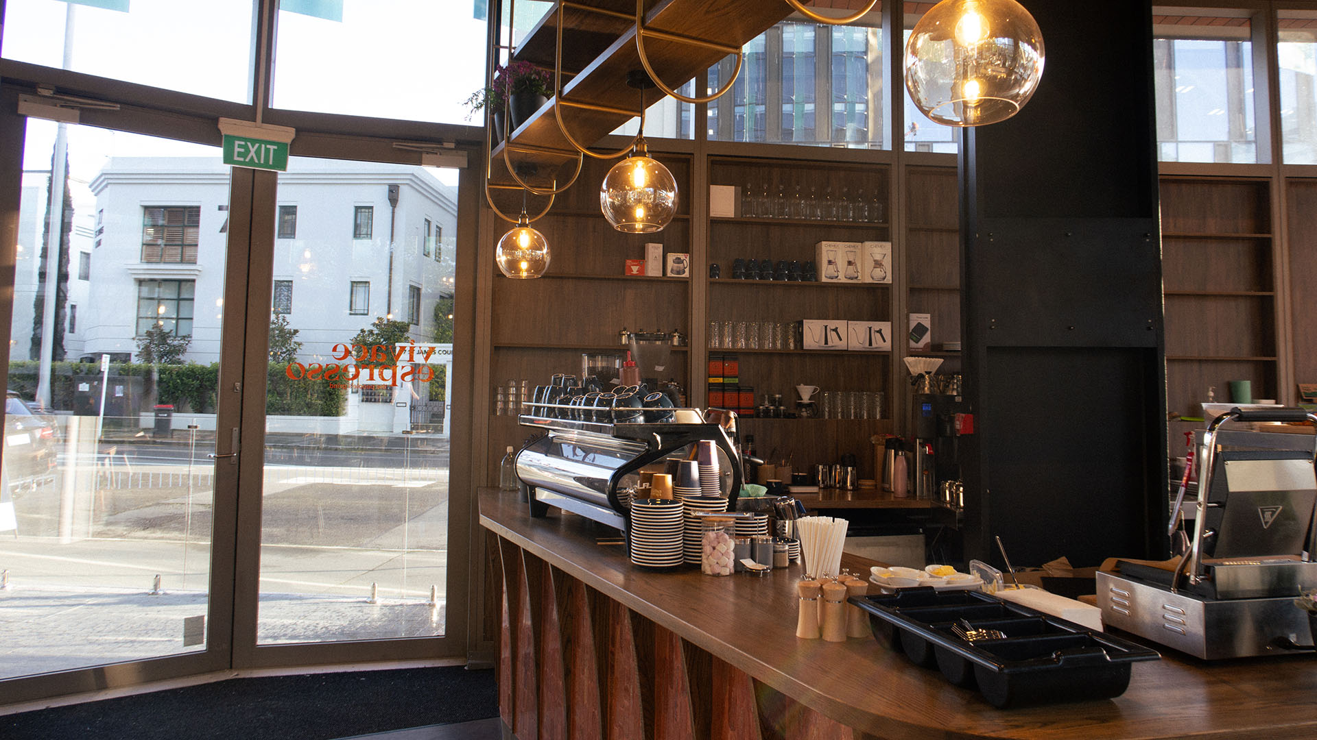 Vicace Espresso Cafe-4 Cafe counter with a coffee machine on a timber counter top, and warm down lights.