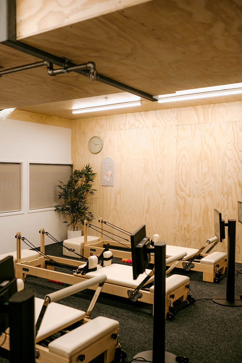 Basin with wooden cupboard fronts and featured wall in a new retail interior fitout.