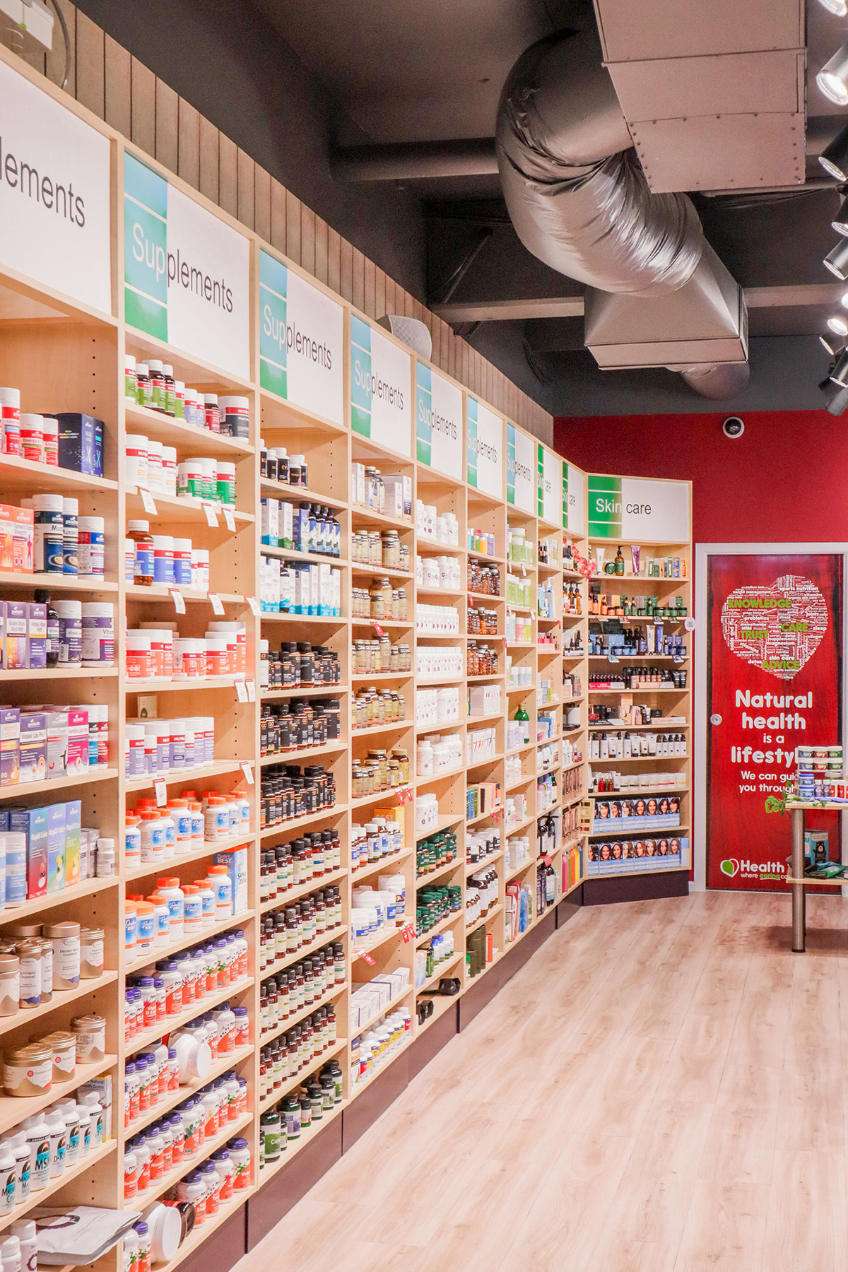 Basin with wooden cupboard fronts and featured wall in a new retail interior fitout.