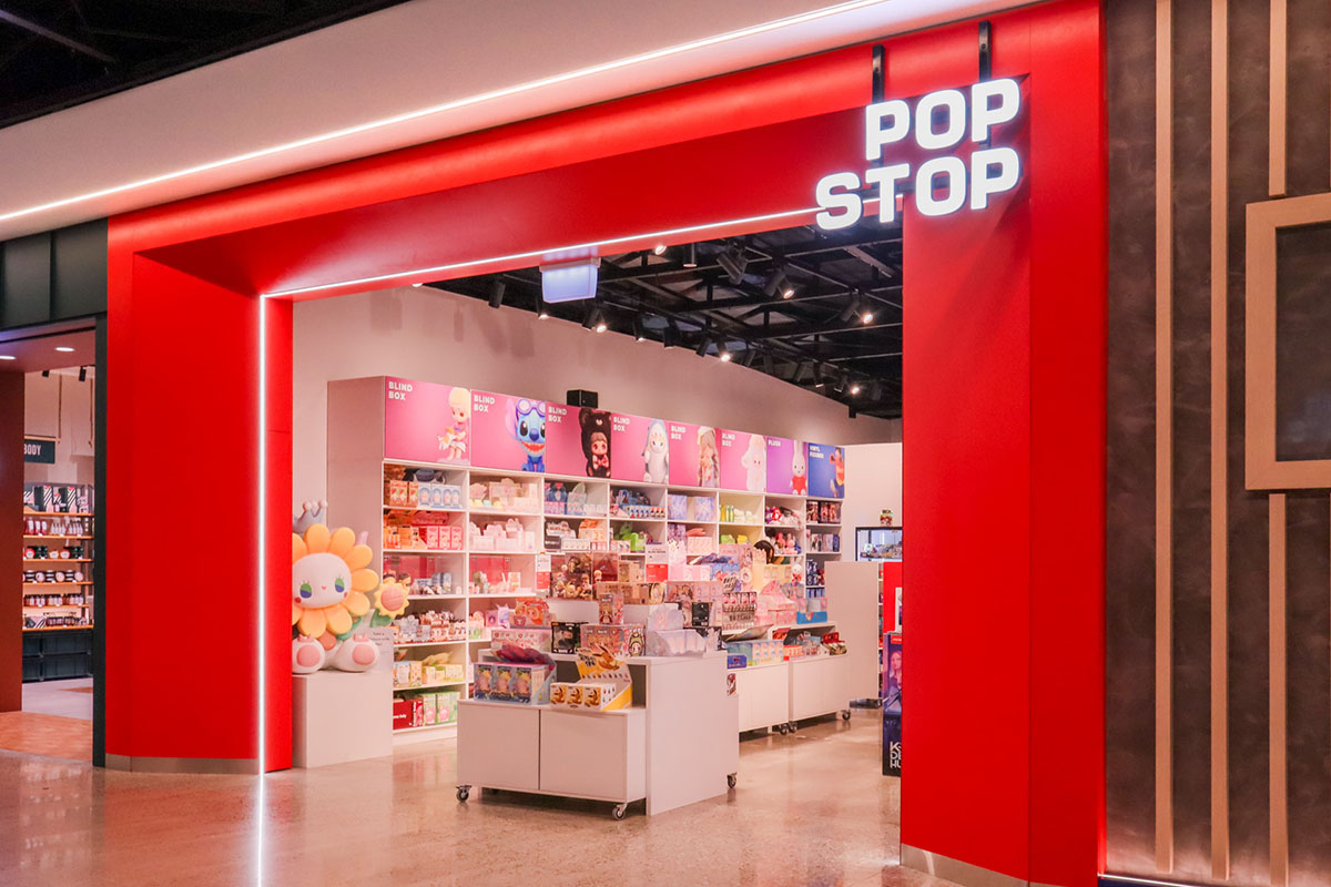 Cafe counter with a coffee machine on a timber counter top, and warm down lights.