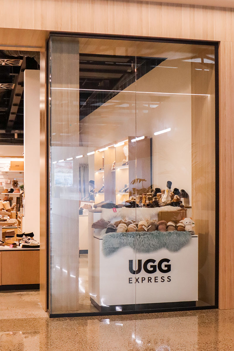 Basin with wooden cupboard fronts and featured wall in a new retail interior fitout.
