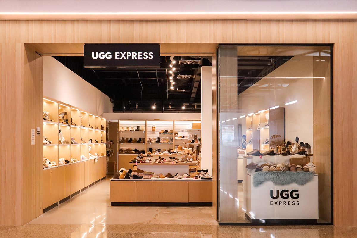 Cafe counter with a coffee machine on a timber counter top, and warm down lights.