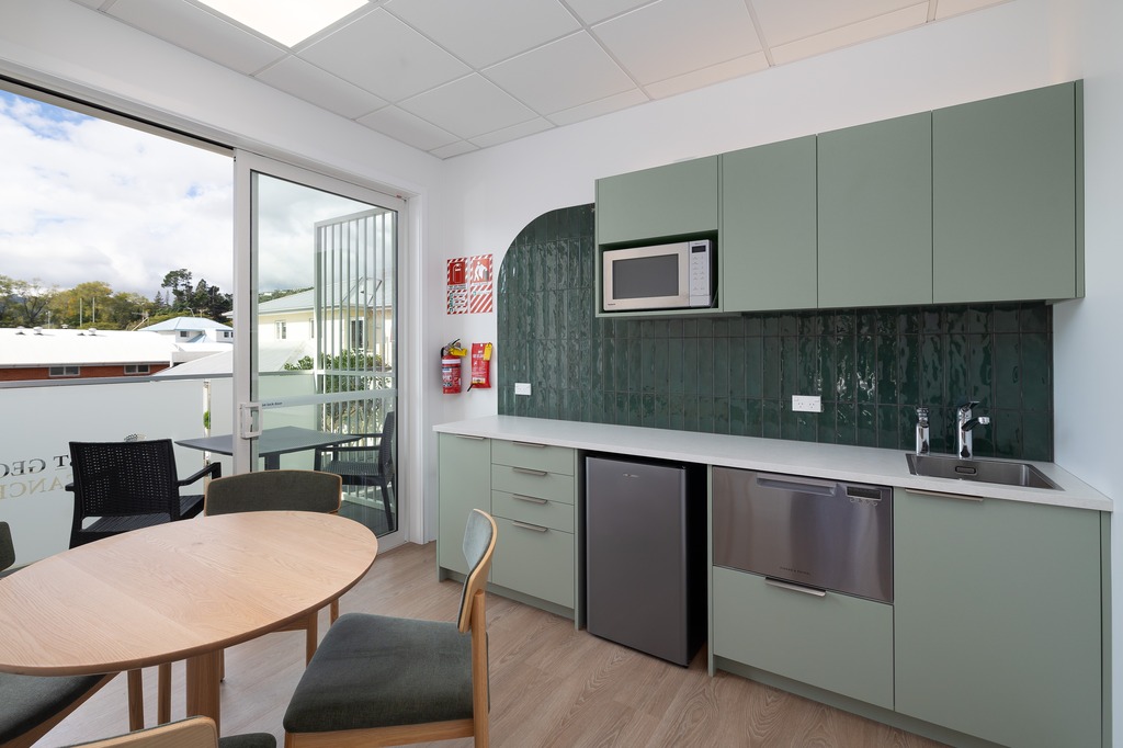 Basin with wooden cupboard fronts and featured wall in a new retail interior fitout.