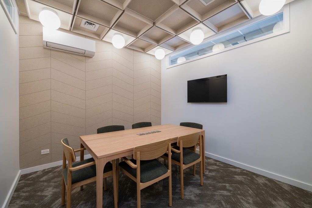 Reception area of a nail salon with bench seating along the wall. 
