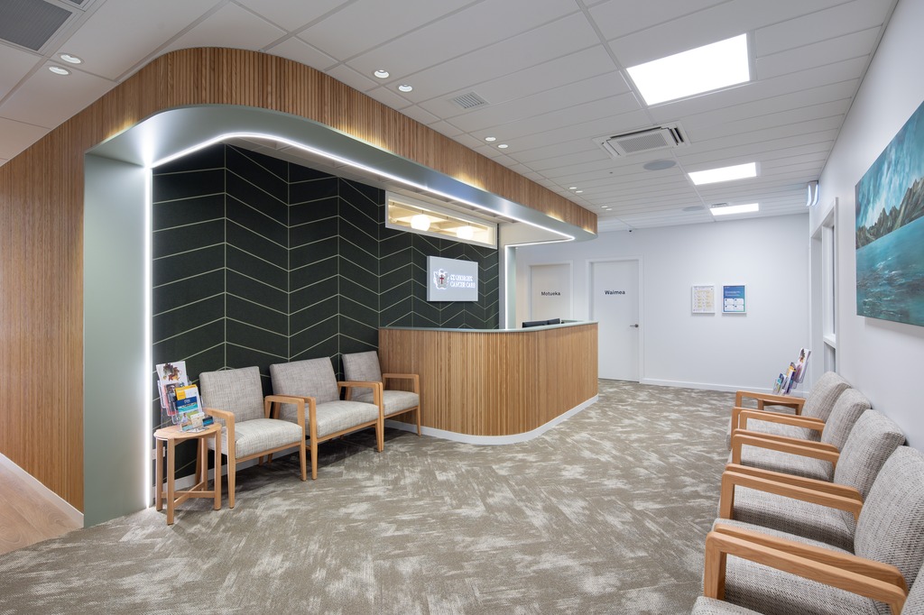 Cafe counter with a coffee machine on a timber counter top, and warm down lights.