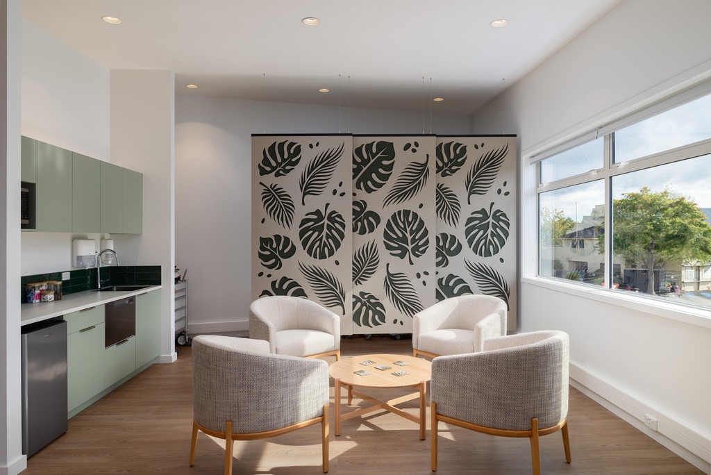 Basin with wooden cupboard fronts and featured wall in a new retail interior fitout.