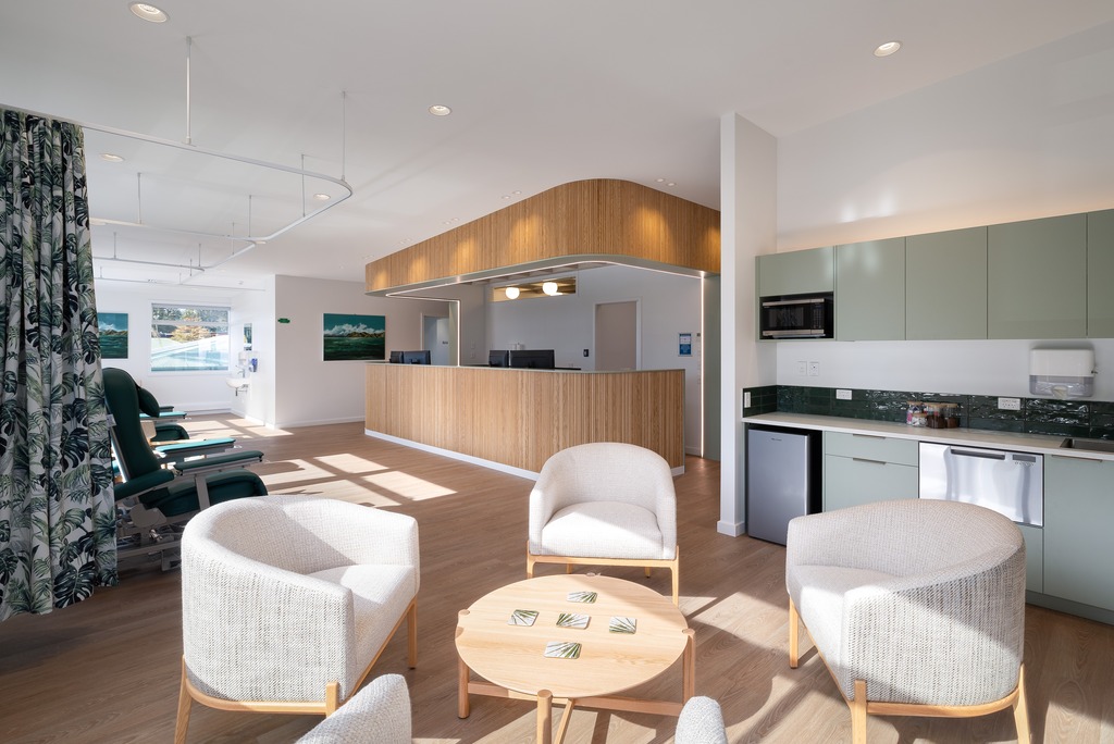 Reception area of a nail salon with bench seating along the wall. 