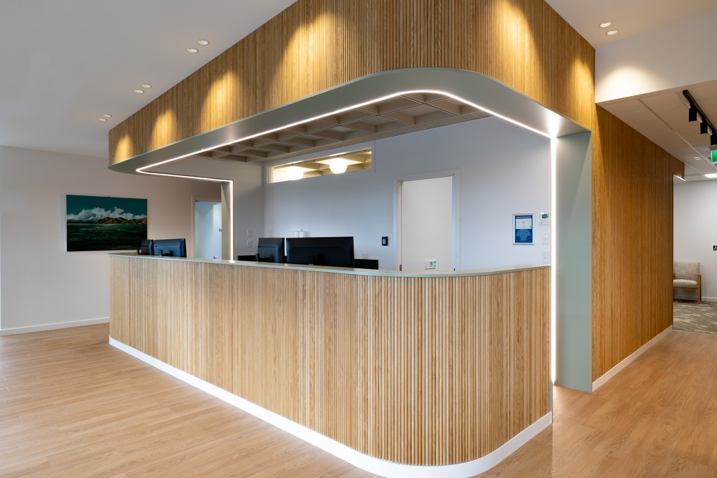 Reception area of a nail salon with bench seating along the wall. 
