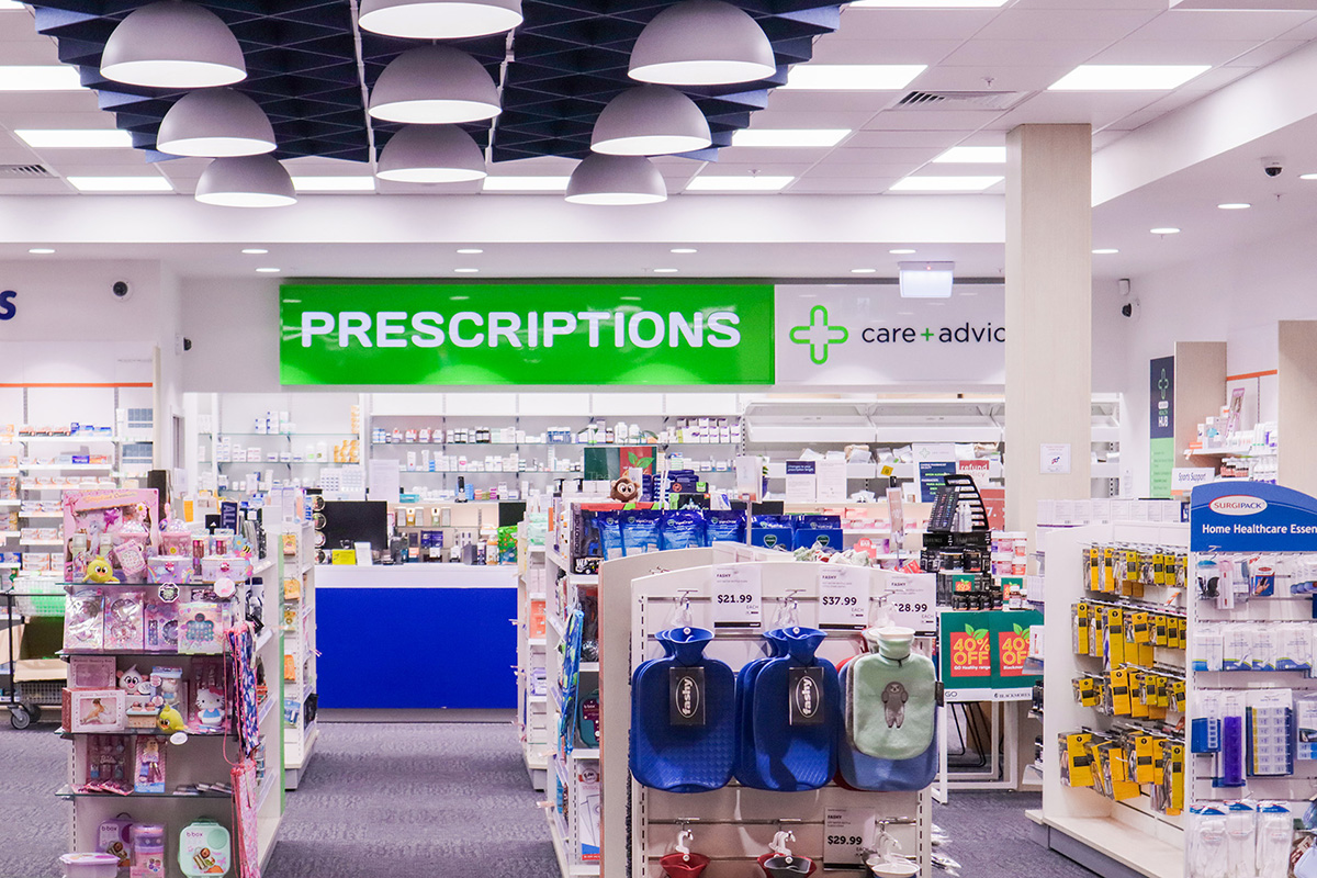 Basin with wooden cupboard fronts and featured wall in a new retail interior fitout.