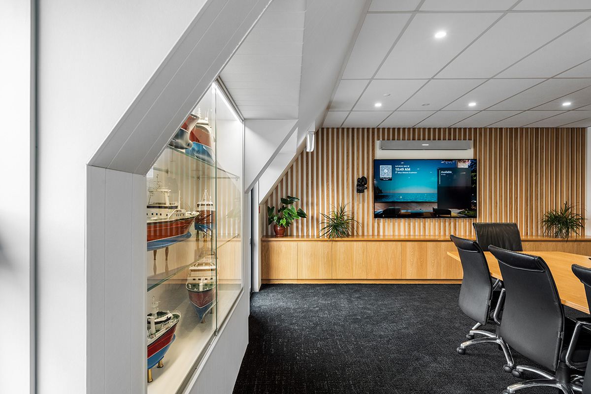 Basin with wooden cupboard fronts and featured wall in a new retail interior fitout.