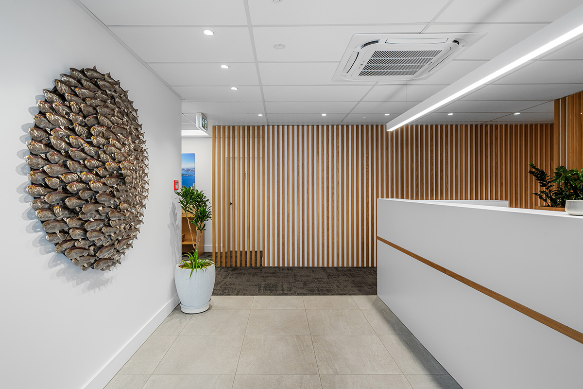 Basin with wooden cupboard fronts and featured wall in a new retail interior fitout.